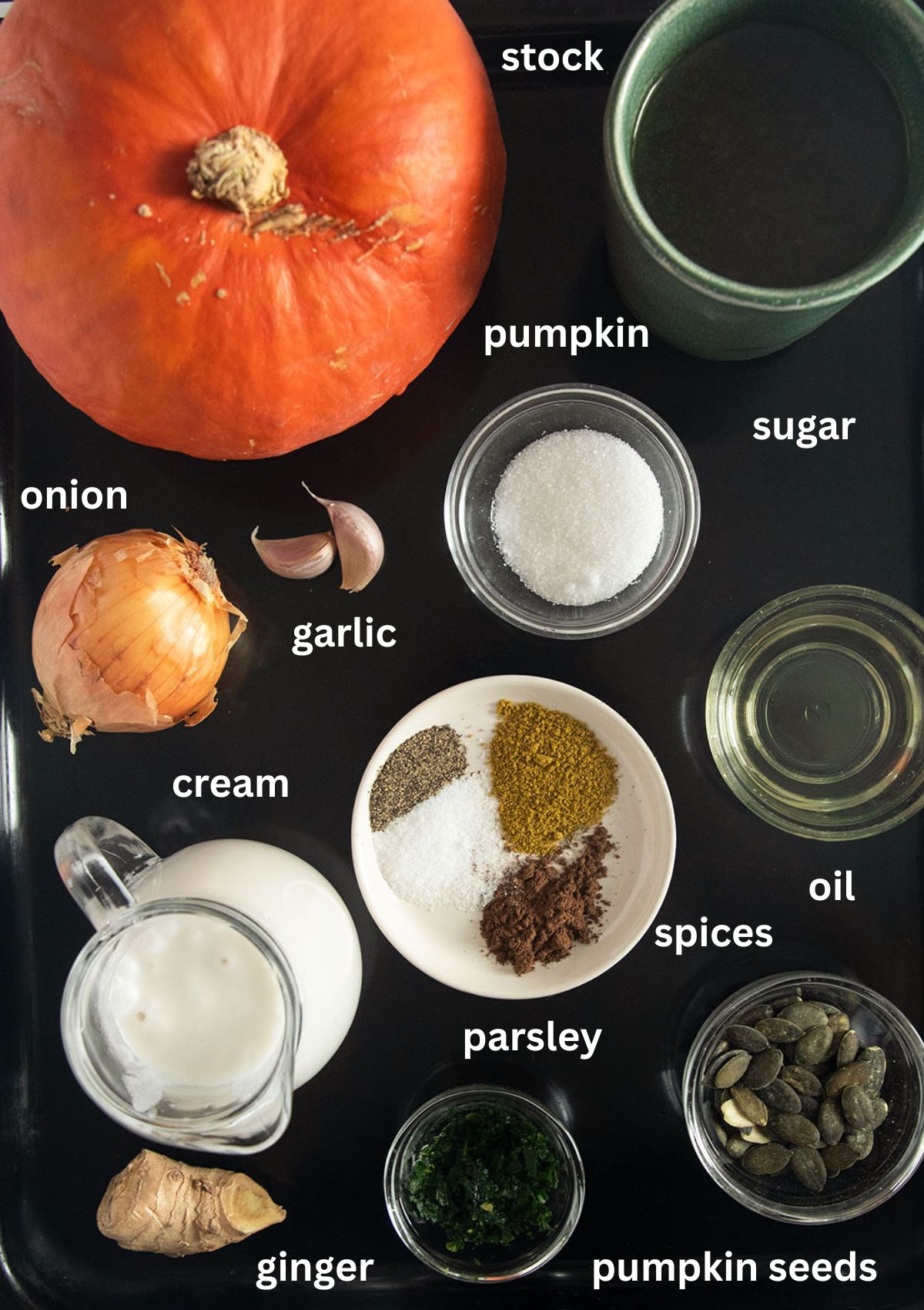 labeled ingredients for making pumpkin ginger soup with spices and cream.