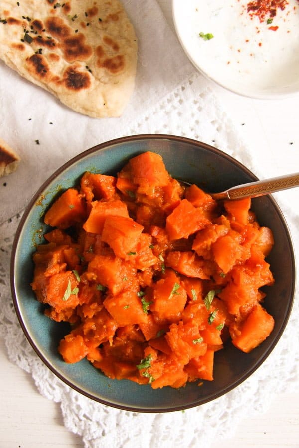 spicy pumpkin cubes braised with spices and served with naan bread and yogurt.