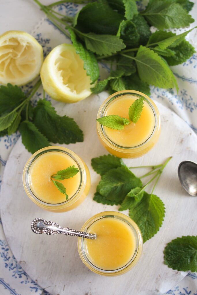 jars of dessert garnished with lemon balm