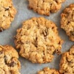 mueli cookies with nuts, cranberries and peanut butter on parchment paper.