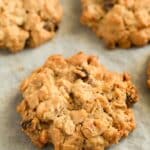 Close-up of a chewy homemade muesli cookie with cranberries, raisins, and walnuts pin image.
