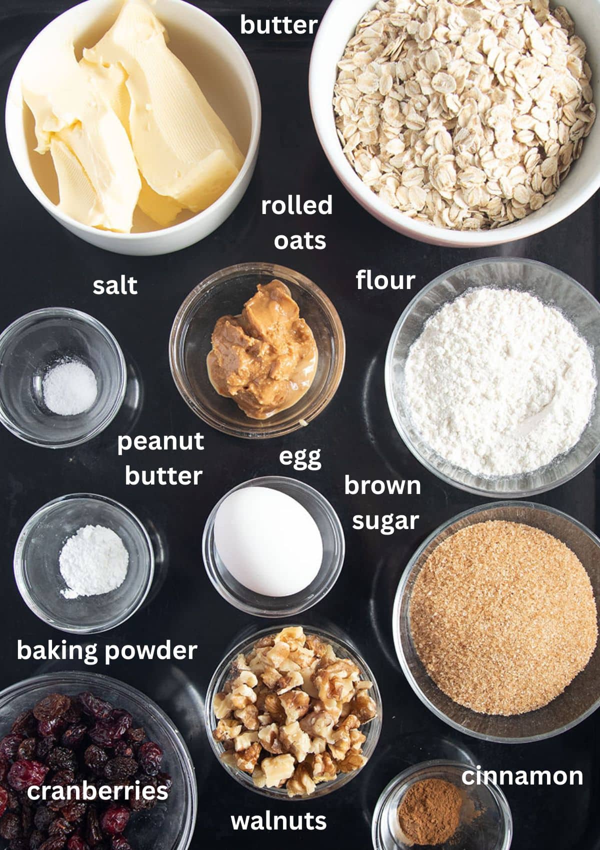 Ingredients for chewy muesli cookies with peanut butter, cranberries, raisins, and walnuts.