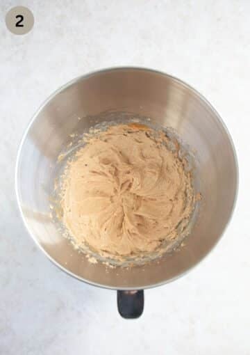 Adding peanut butter and egg to cookie dough.