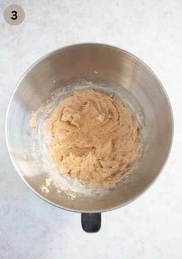 adding mixed flour and baking powder to dough for making muesli cookies.