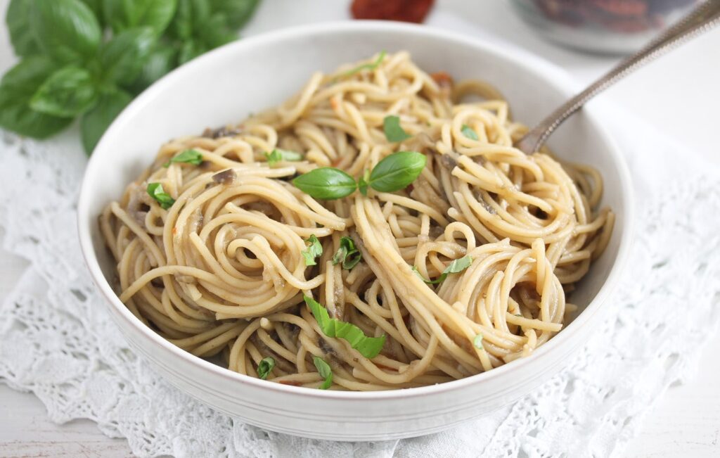 white bowl full of pasta with aubergine sauce