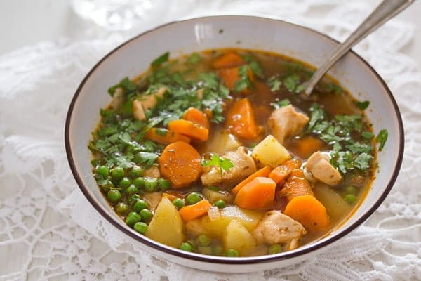 bowl of chicken and potato soup sprinkled with parsley