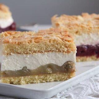 cheesecake with berries sliced on a white platter