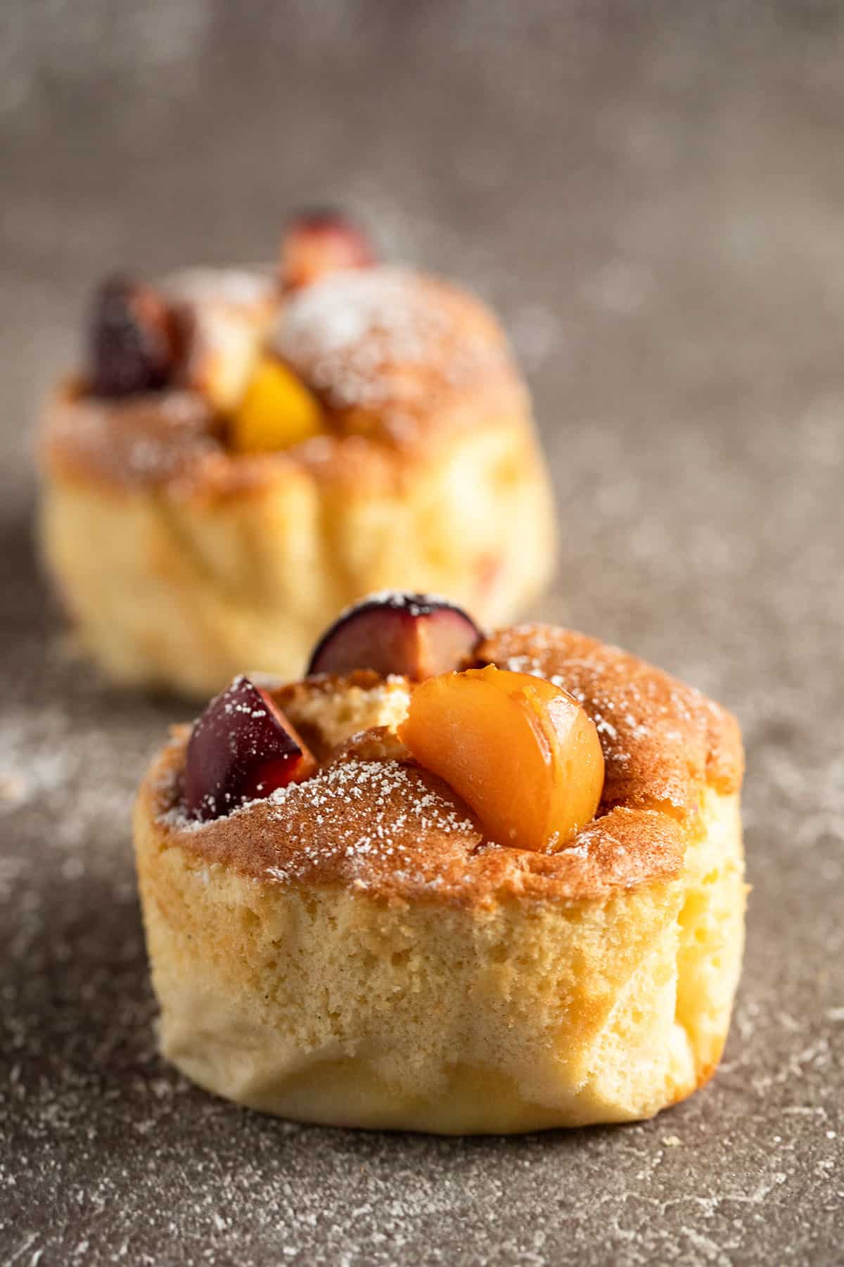 two small plum clafoutis with sliced plums on top.