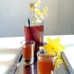 small bottle and two shot glasses with honey liqueur