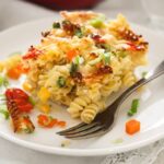ham and cheese pasta bake with tomatoes and peppers on a plate