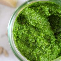overhead view of green pesto in a jar.