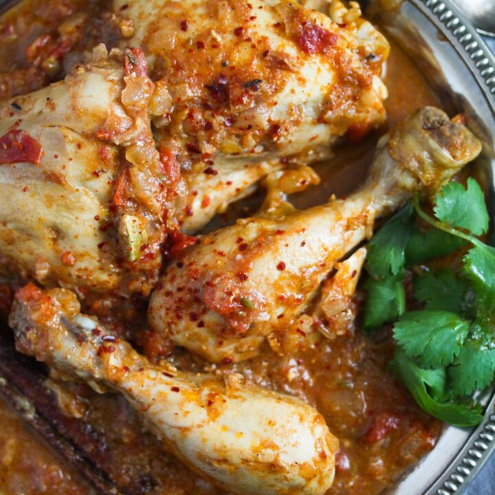 plate with chicken legs in curry sauce