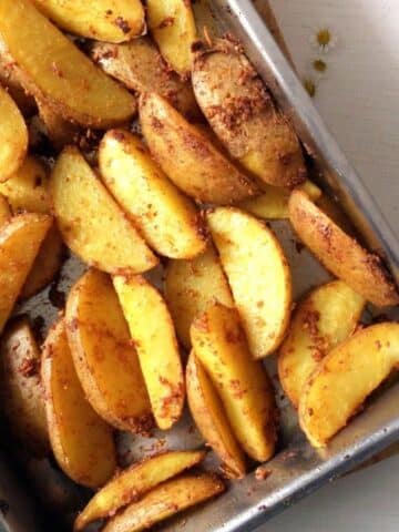 potato wedges in a roasting tin.