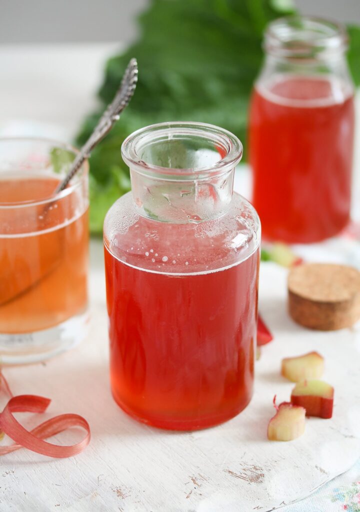 bottles of pink drink made from rhubarb peel