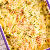 casserole dish with potatoes and broccoli seen from above.