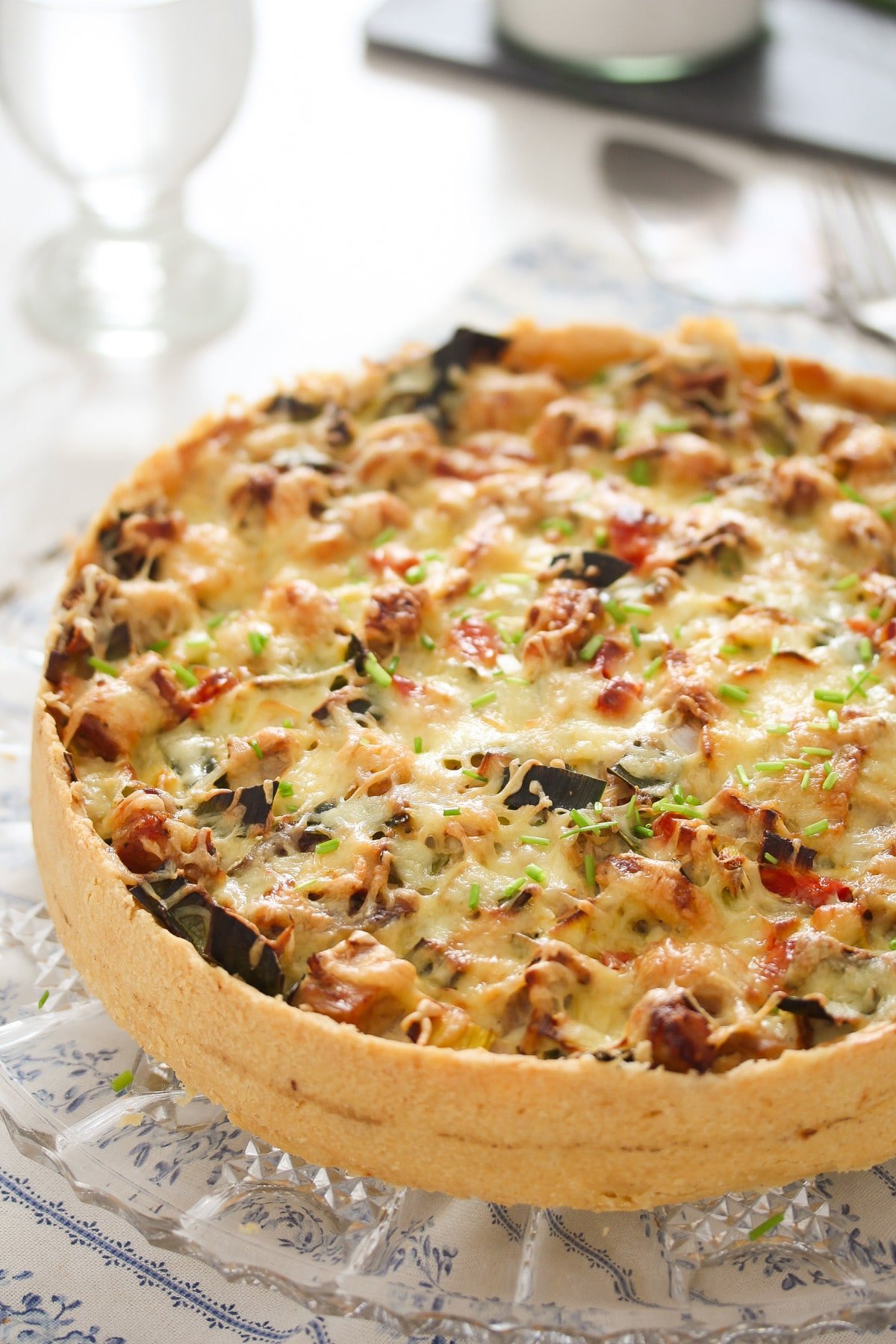 round pie with chicken and vegetables on the table