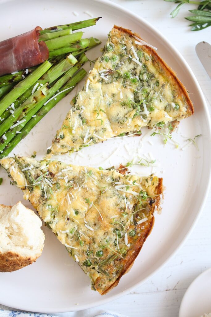 wedges of frittata served with asparagus and ham on a plate