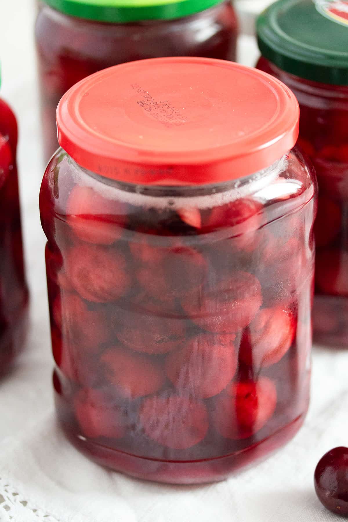 one large jar containing preserved cherries made at home.