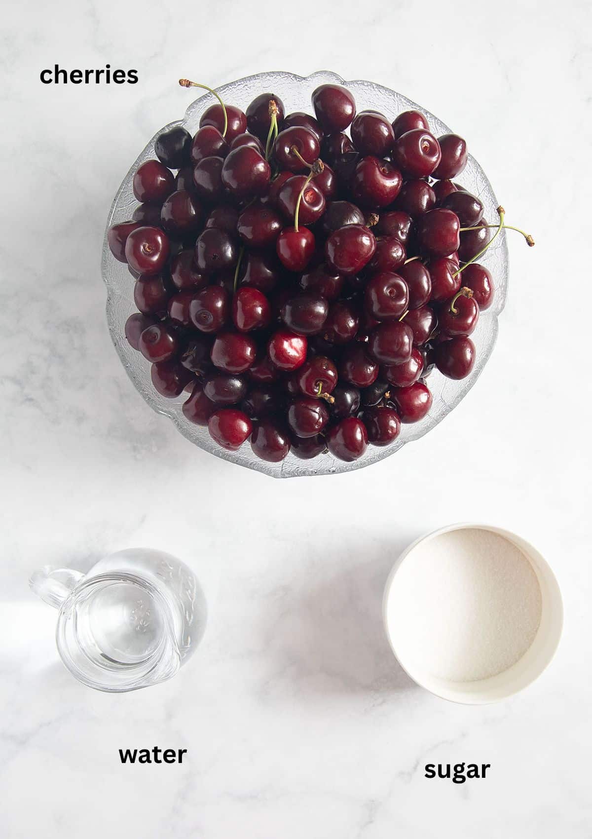 flat lay of labeled ingredients for preserving cherries with sugar and water.