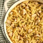 pinterest image of a large dutch oven with chicken fusilli pasta in it.