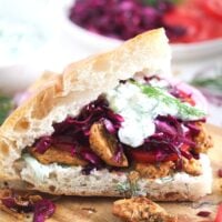 german gyros or doner kebab with tzatziki on a wooden board.