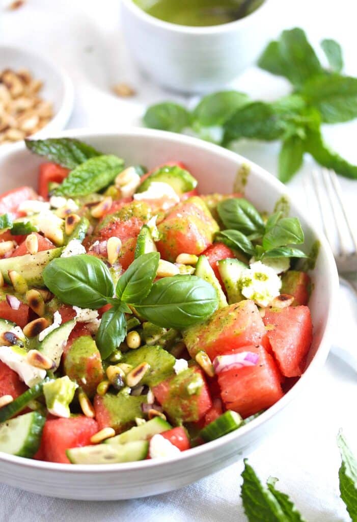 bowl of watermelon feta balsamic salad with fresh basil on top