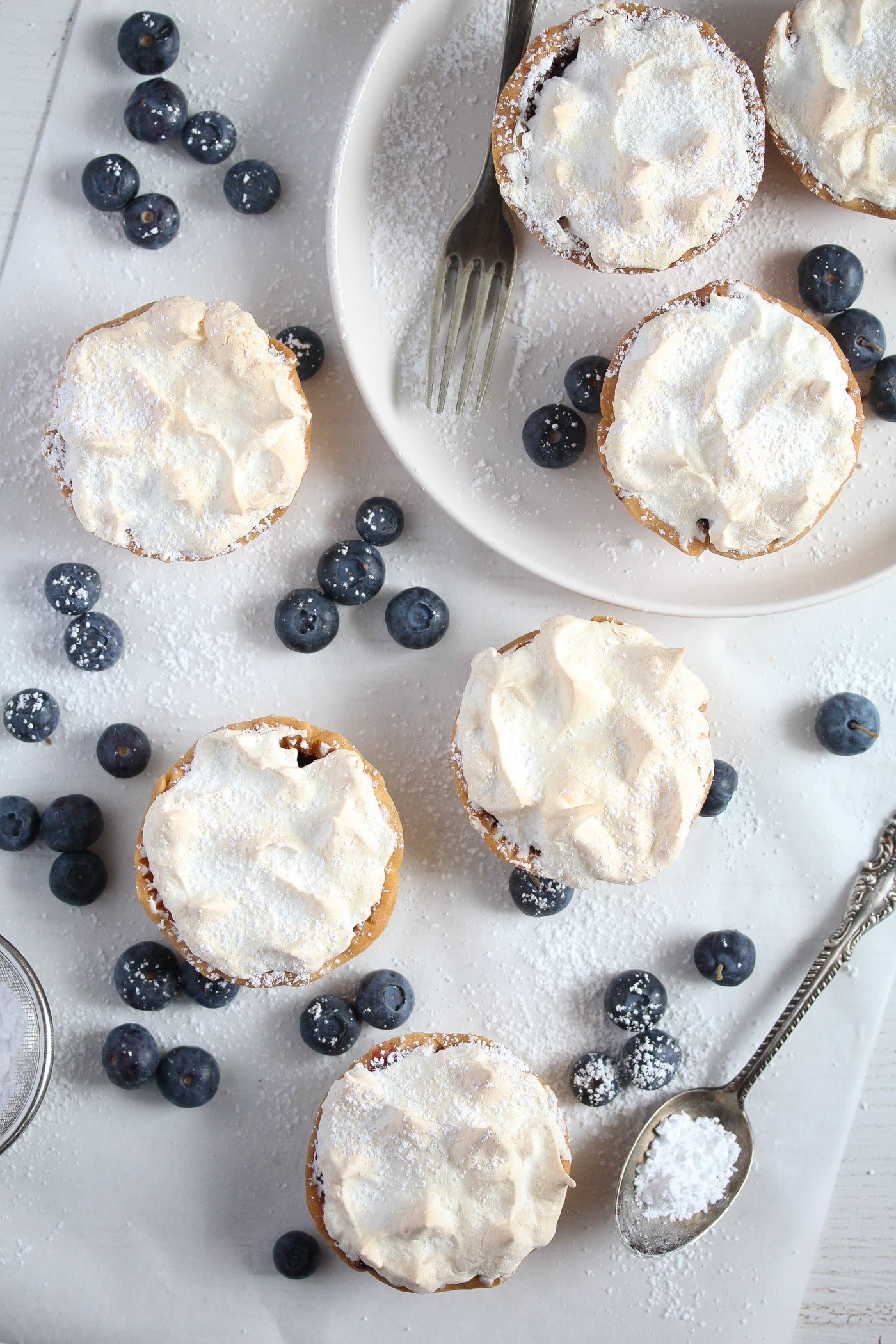 many little tarts with blueberries on the table