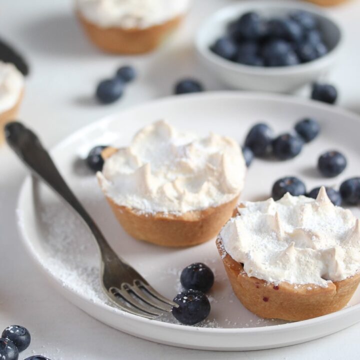 meringue blueberry tartlets on a small white plate