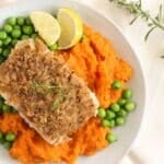 pinterest image with title of salmon on top of sweet potato mash with peas.