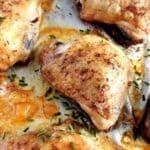 golden baked chicken thighs on aluminum foil.