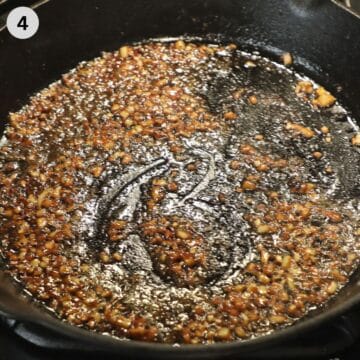cooking onions for blueberry sauce in a pan.