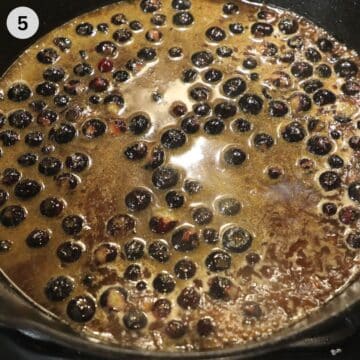 making blueberry sauce for turkey in a skillet.