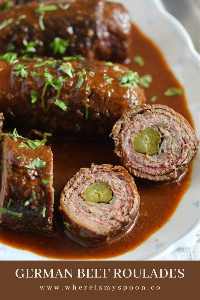 sliced roulades of beef with pickled cucumbers in the middle and lots of sauce