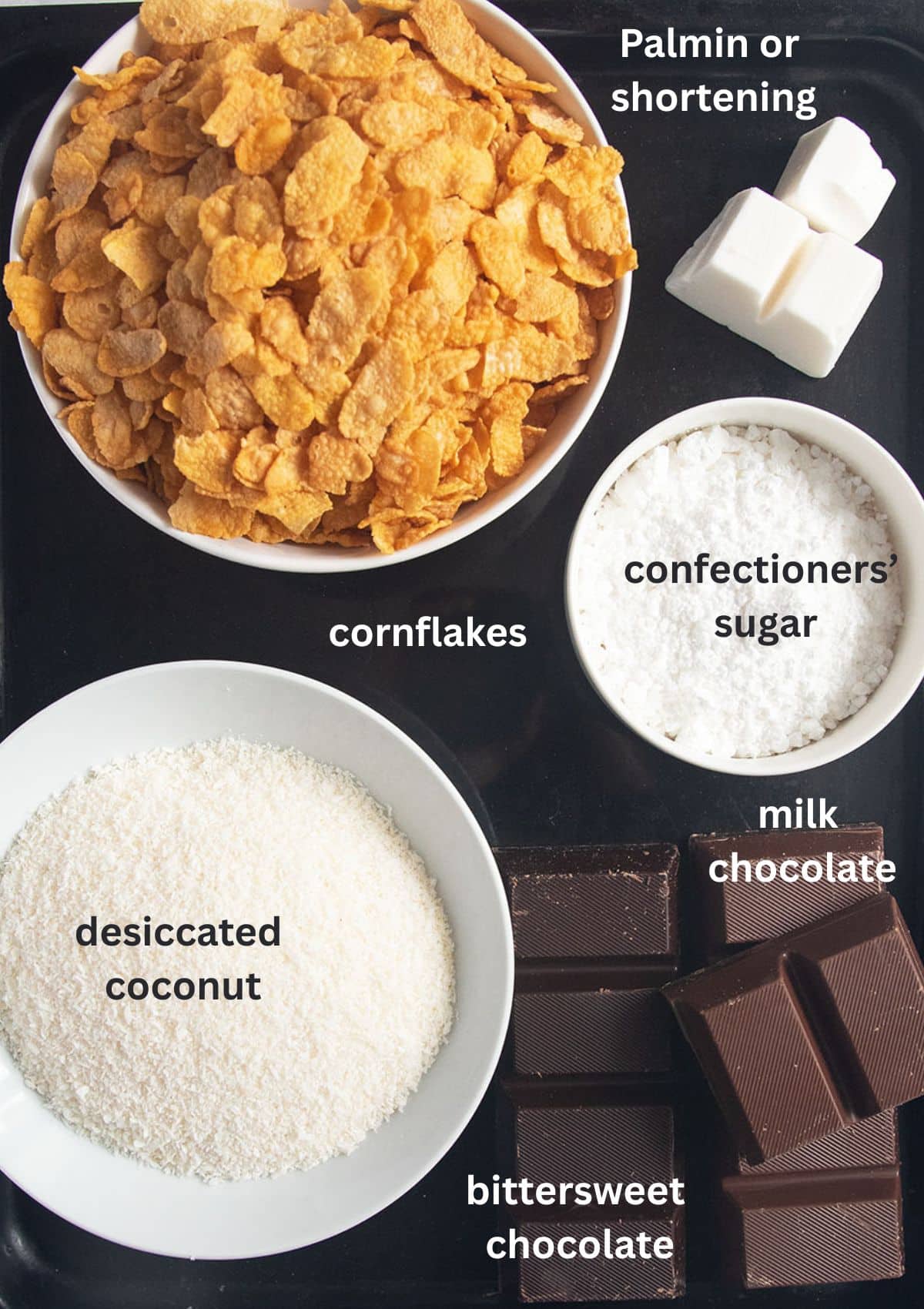 labeled ingredients for making choco crossies recipe: cornflakes, shorteniing, sugar, coconut, and chocolate.