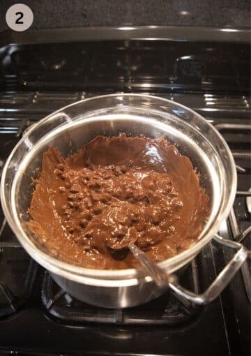 melting chunky chopped chocolate in a large bowl over a pot of hot water.