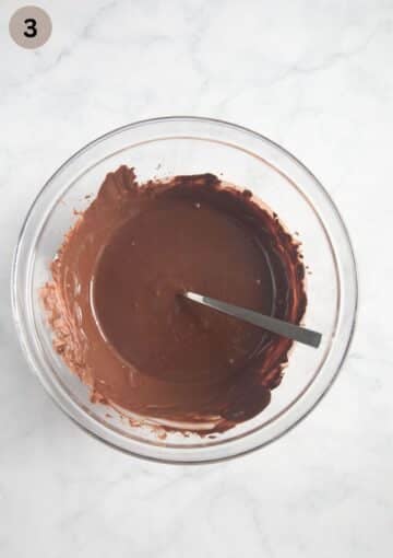 melted chocolate mixed with shortening in a large bowl for making a german choco crossies recipe.