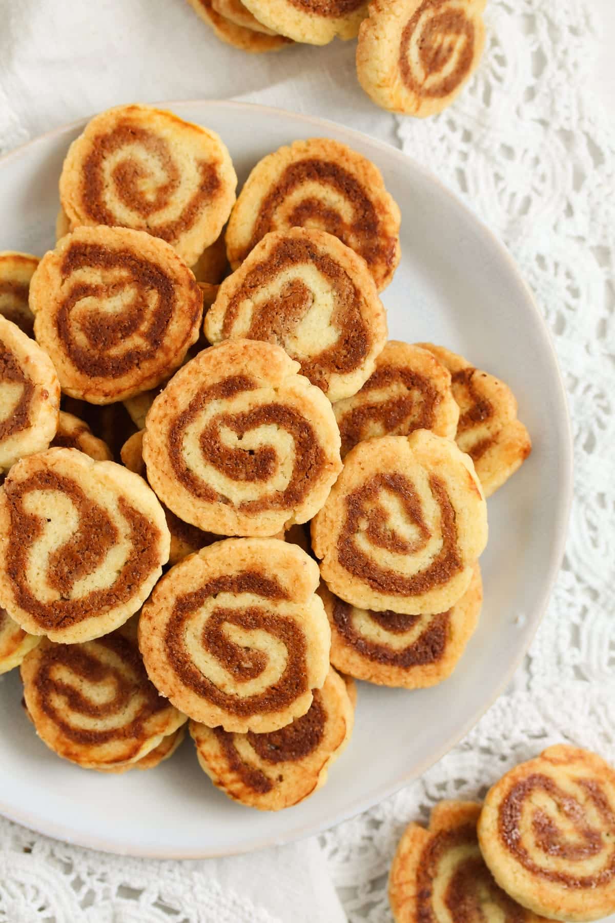 german swirl cookies with walnut marzipan filling on a plate.