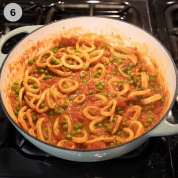 calamari rings cooking int tomato sauce in a large dutch oven.