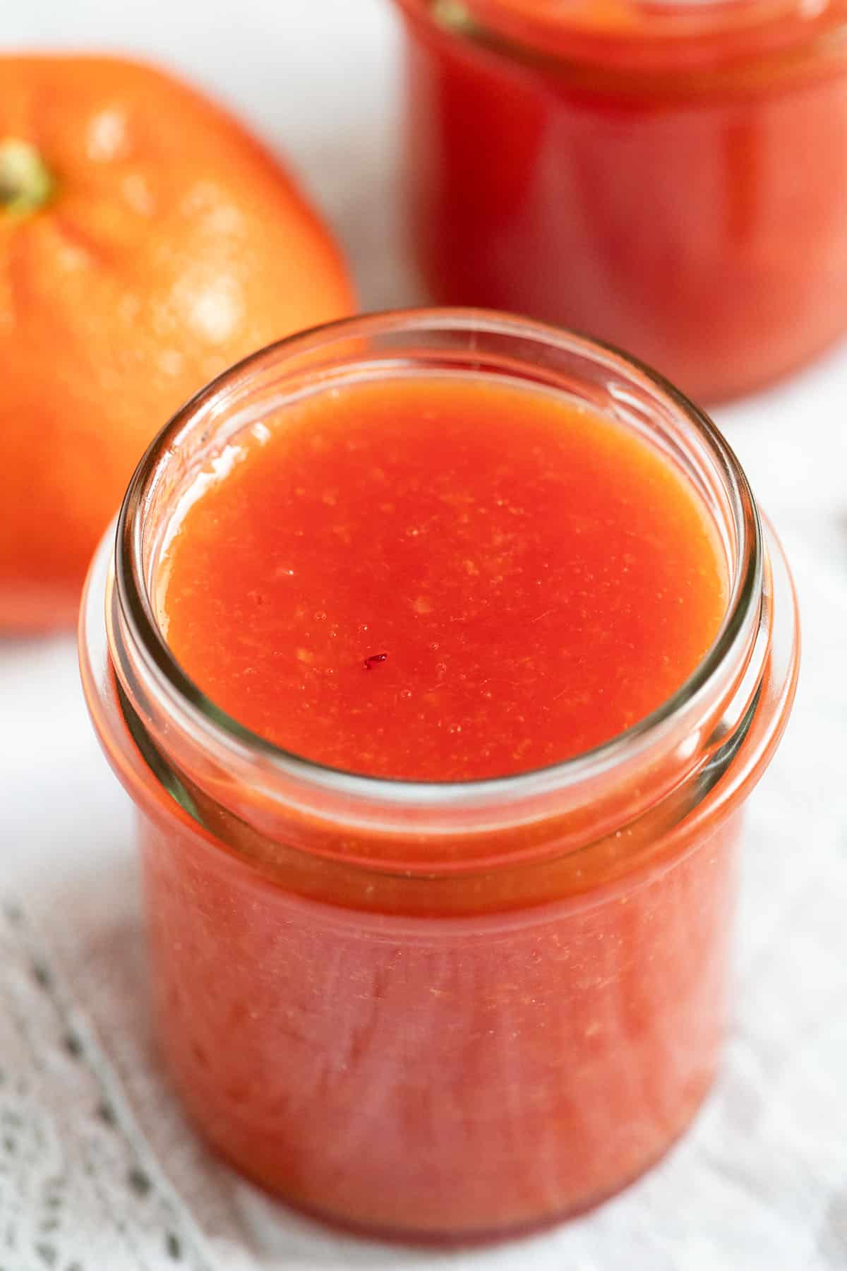 jam made with oranges and lemon juice in a small jar.
