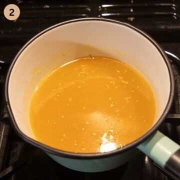 making orange sauce for chicken in a small saucepan.