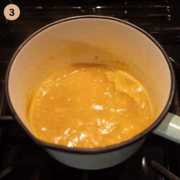 simmering orange sauce for chicken in a small saucepan.