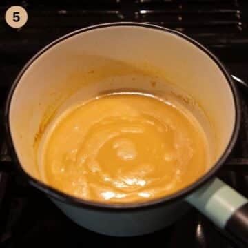 finished orange sauce for chicken in a small pot.