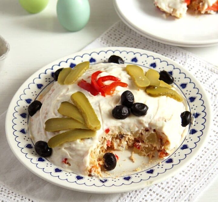Romanian salad de boeuf decorated with mayonnaise and olives
