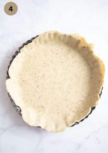 rolled dough in a quiche dough before baking.