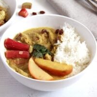 rhubarb chicken curry in a white bowl on the table