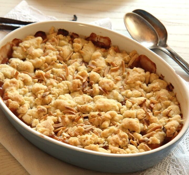 rhubarb apple crumble with streusel in a blue baking dish.