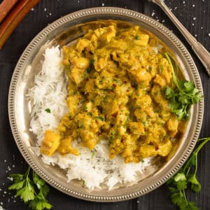 rhubarb fish curry with rice on a plate.