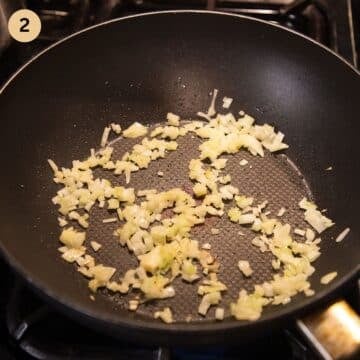 sauteing onions and garlic in a pan.