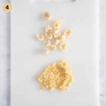 chopped banana and mashed banana on a cutting board.