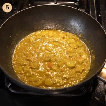 simmerring fish and rhubarb curry in a saucepan.